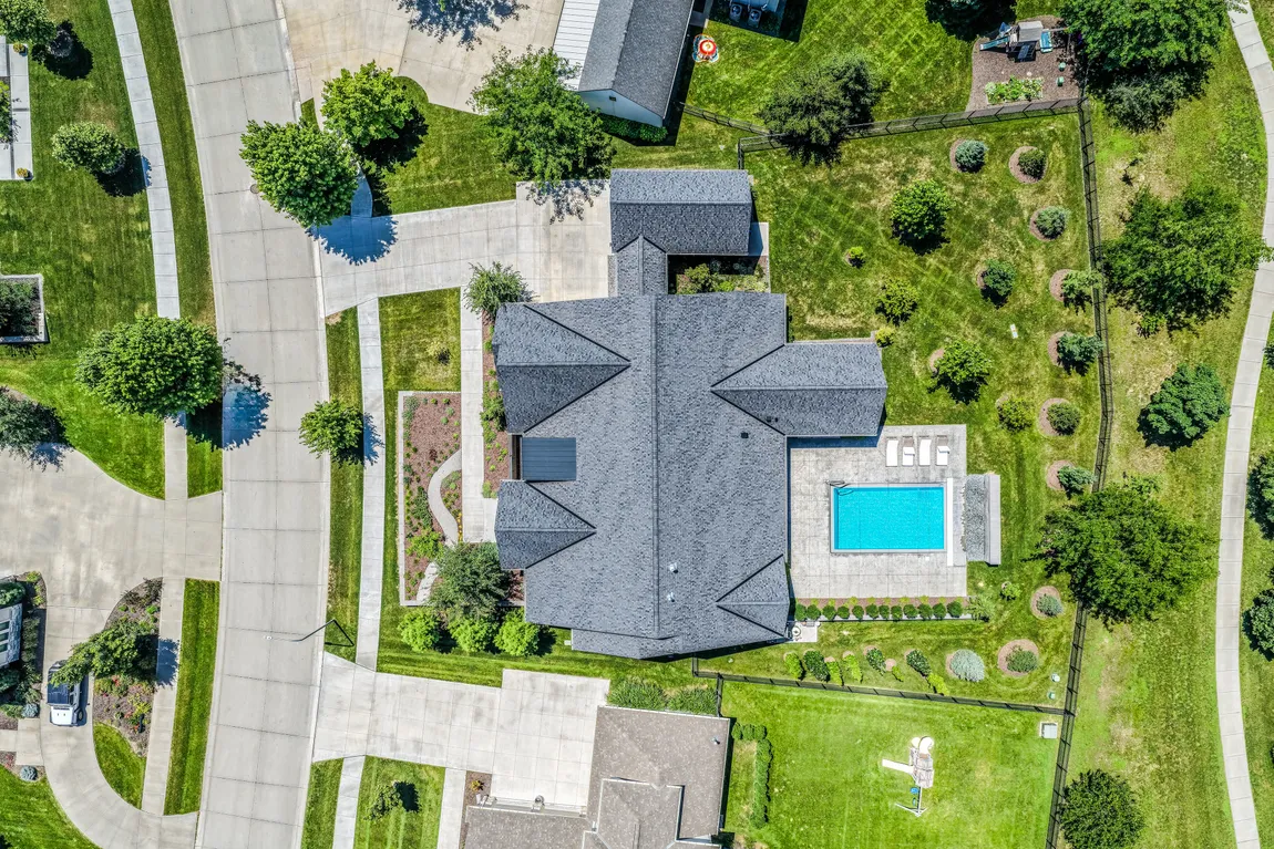 Straight-down aerial view of a large home with a backyard pool