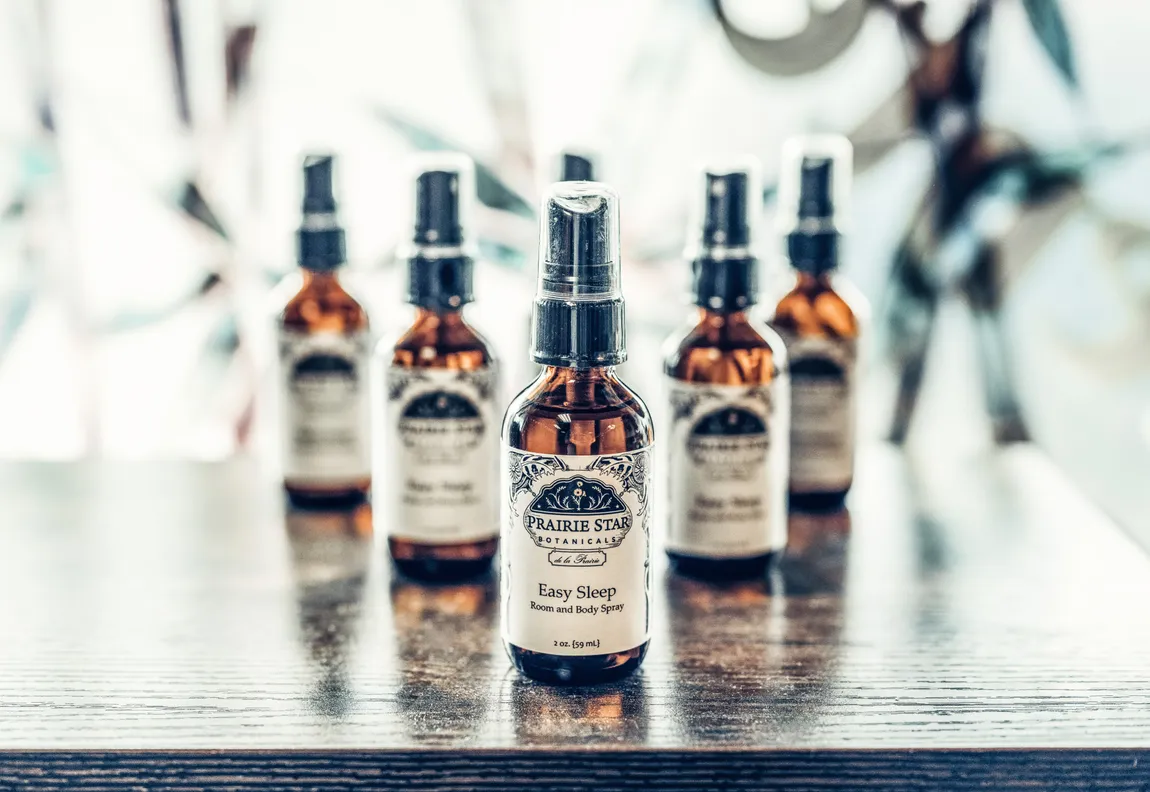 Product photography of amber glass botanical spray bottles